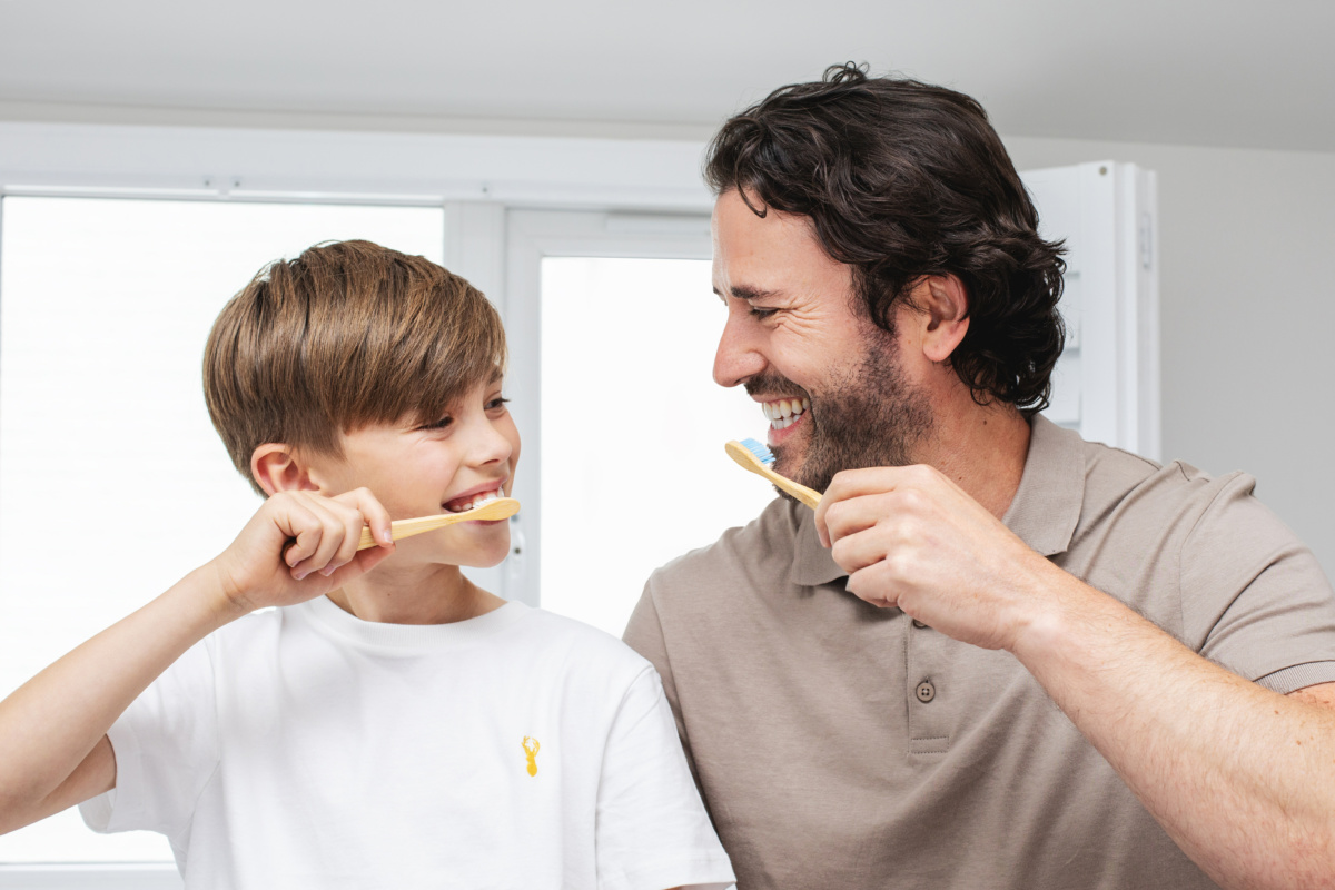 Father and son brushing teeth
