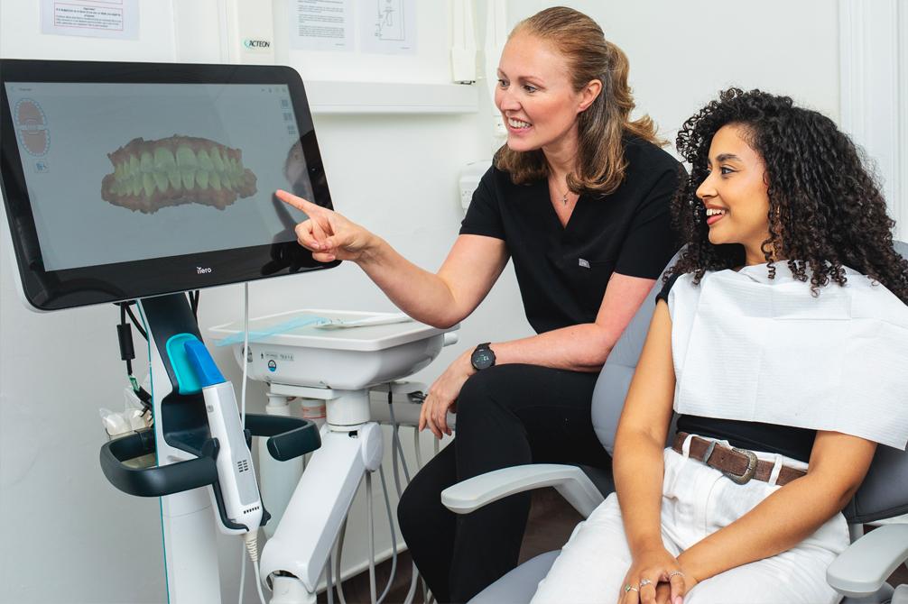 Dentist showing patient a picture of teeth anatomy 